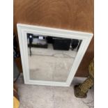 A CREAM FRAMED BEVELED EDGE WALL MIRROR