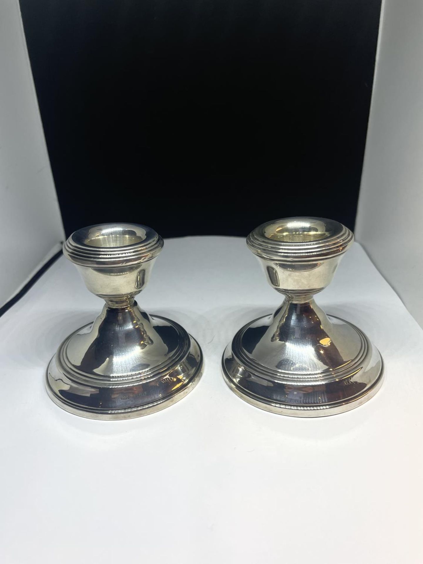 A PAIR OF HALLMARKED BIRMINGHAM SILVER CANDLESTICKS WITH WEIGHTED BASES