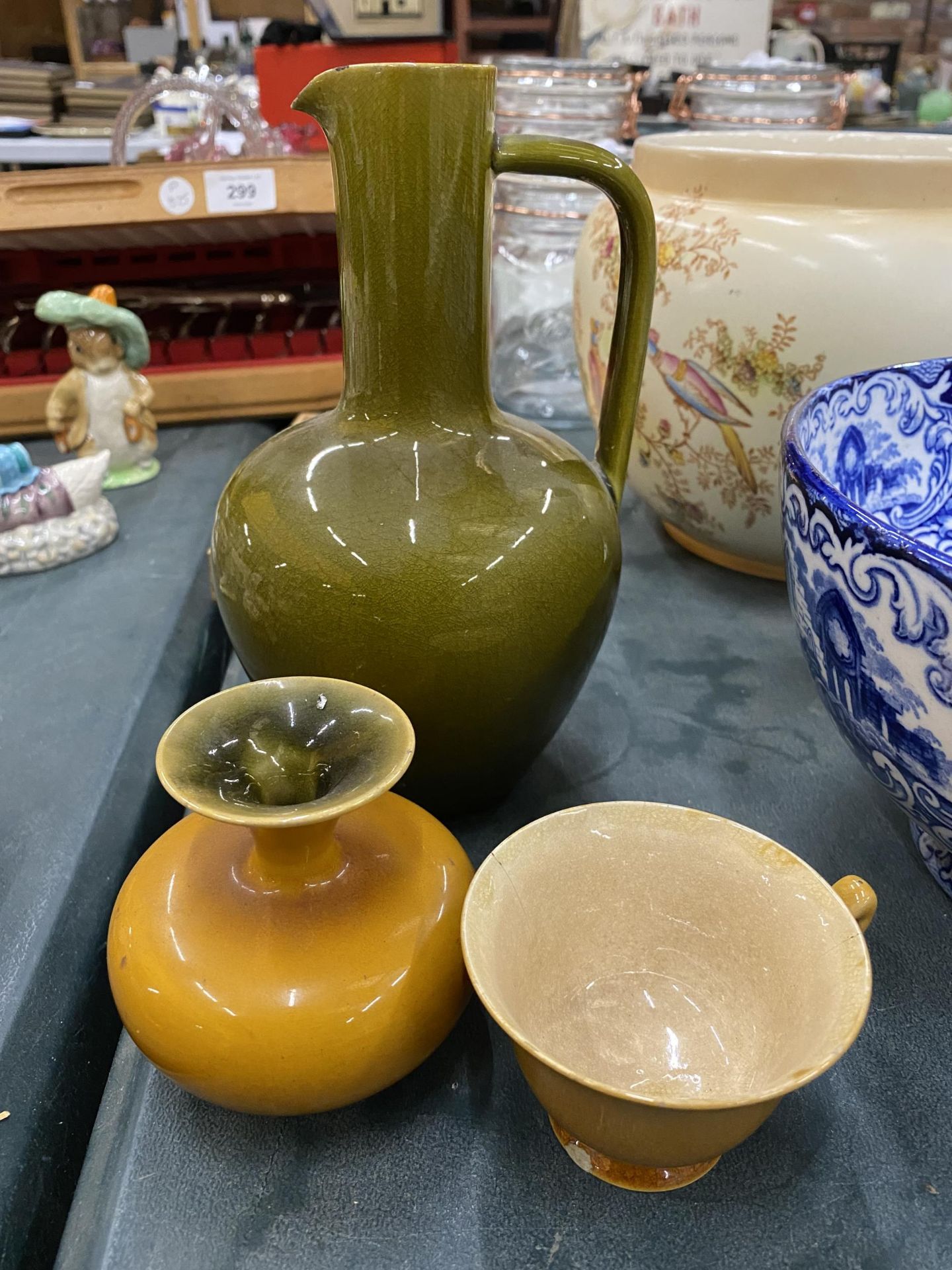 THREE PIECES OF LINTHORPE POTTERY, A GREEN JUG - A/F TO THE SPOUT AND MUSTARD COLOURED CUP AND SMALL