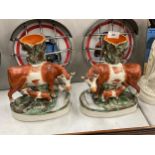 A PAIR OF 19TH CENTURY STAFFORDSHIRE POTTERY COW SPILL VASES