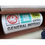 AN ILLUMINATED 'GENERAL MOTORS' SIGN WITH PLUG AND LEAD