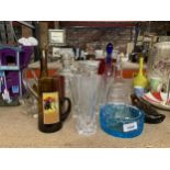 A LARGE QUANTITY OF GLASSWARE TO INCLUDE CUT GLASS VASES, DECANTERS, BOWLS, ETC
