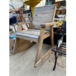 A LARGE HEAVY DUTY WOODEN GARDEN ROCKING CHAIR