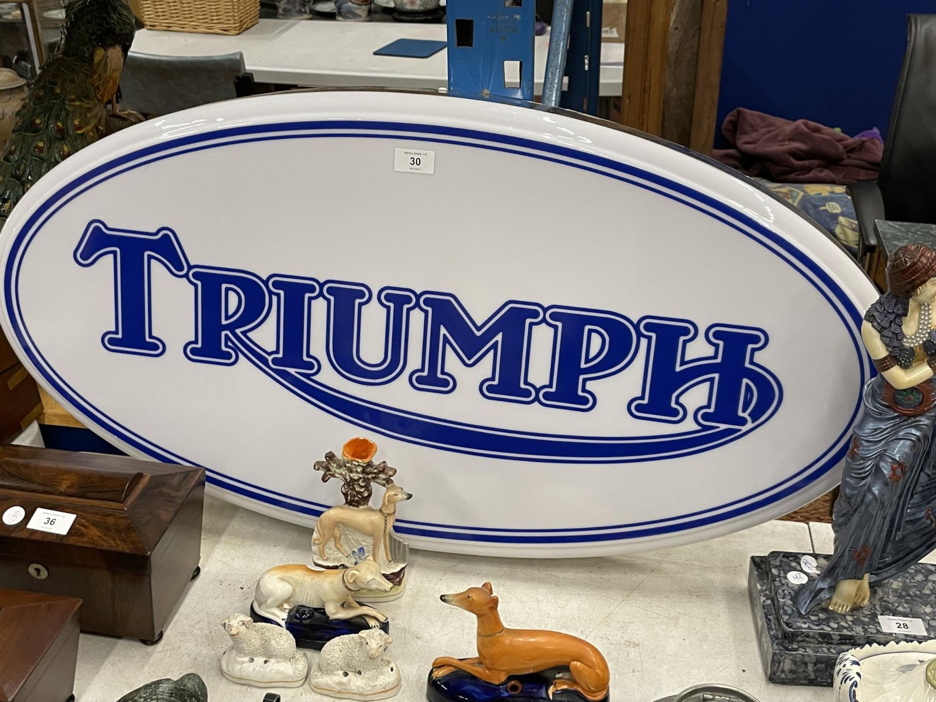 A TRIUMPH ILLUMINATED LIGHT BOX SIGN - WORKING ORDER AT TIME OF CATALOGUING. WIDTH 94CM, HEIGHT