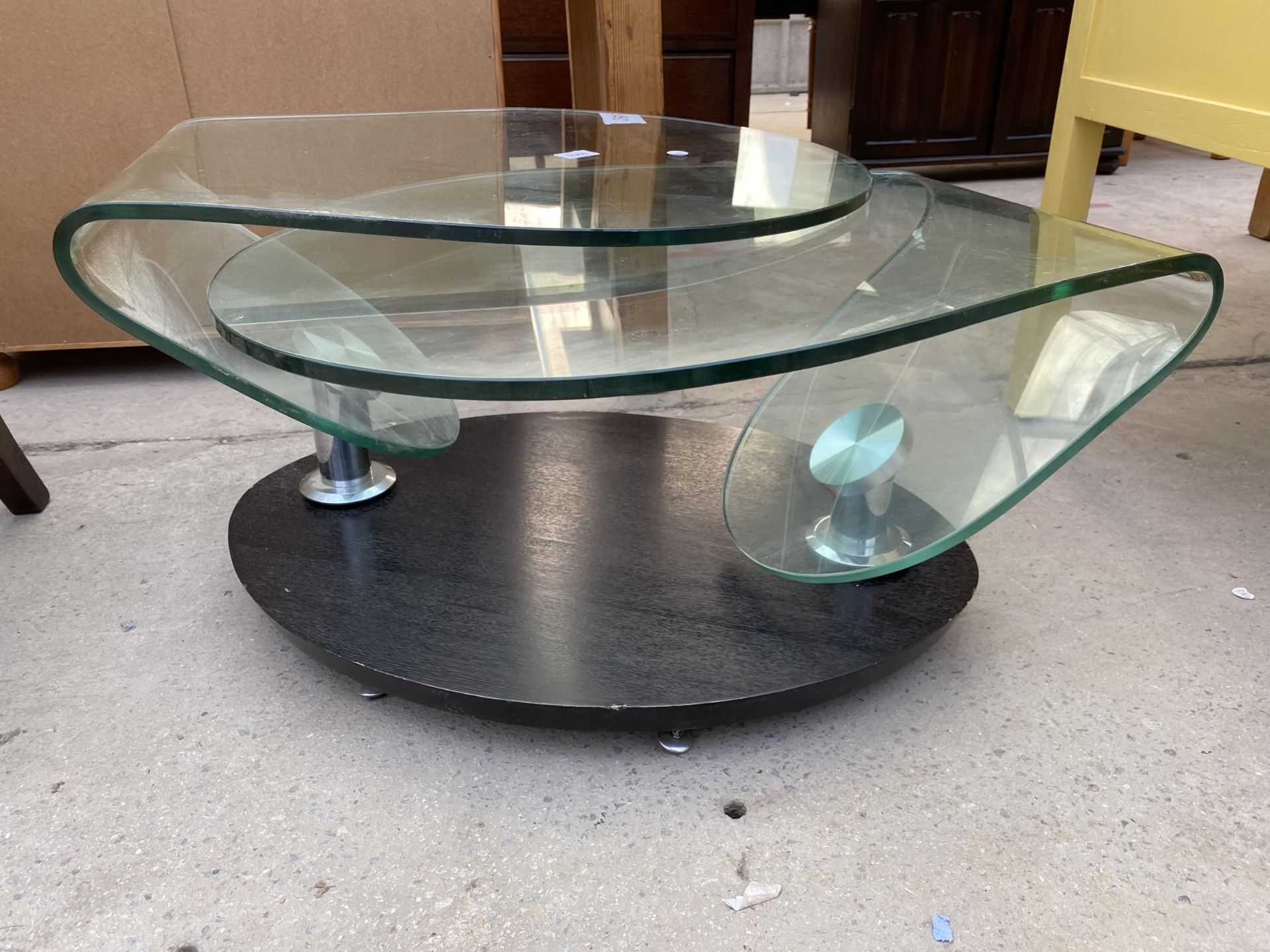 A 1970'S GLASS SWING COFFEE TABLE ON OVAL EBONISED BASE, ENCLOSING CHAIN MECHANISM - Image 2 of 5