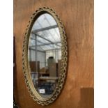 A DECORATIVE GILT FRAMED OVAL WALL MIRROR