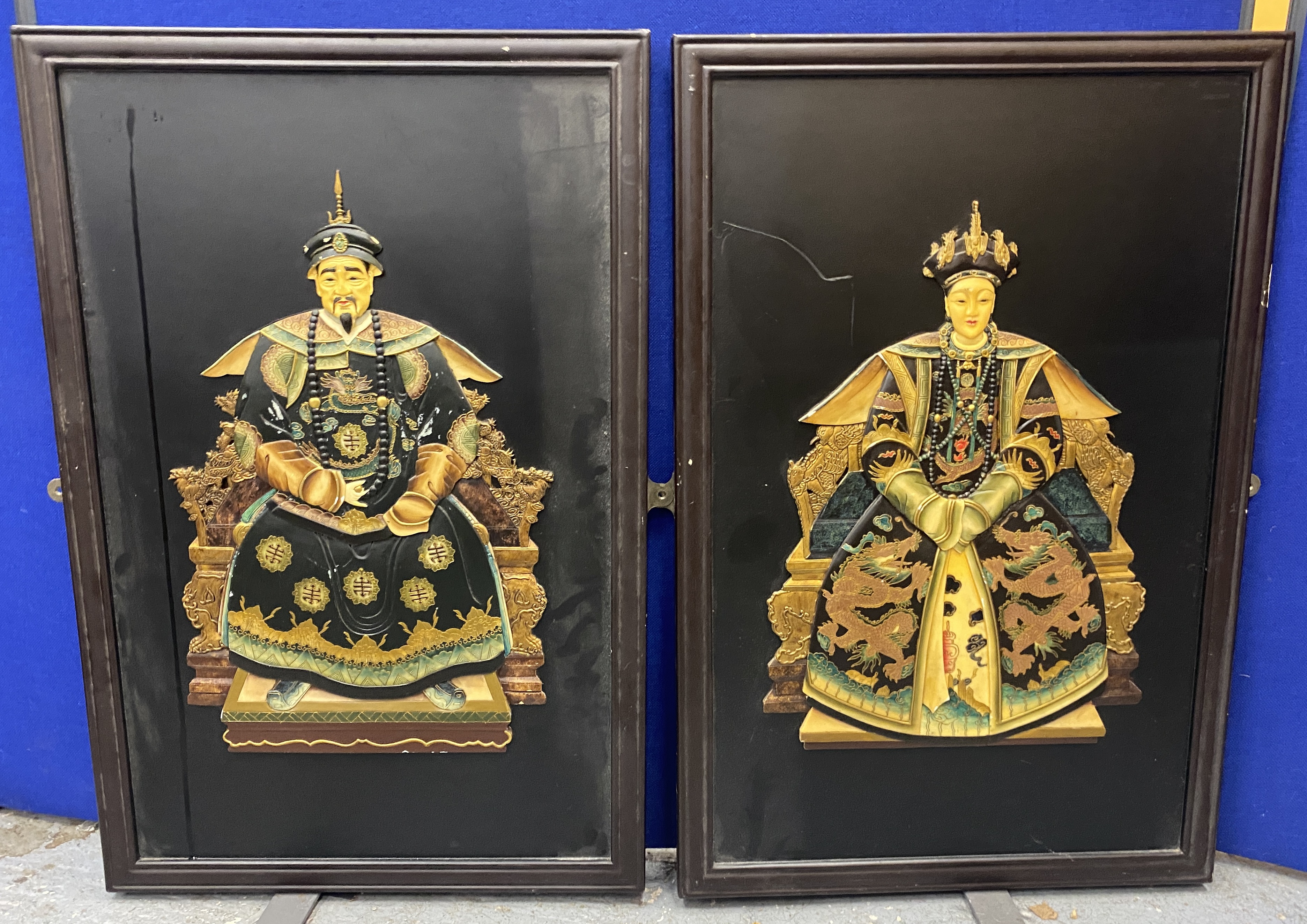 A LARGE PAIR OF ORIENTAL WOODEN FRAMED PLAQUES WITH RESIN FIGURAL DESIGN, 91 X 61CM