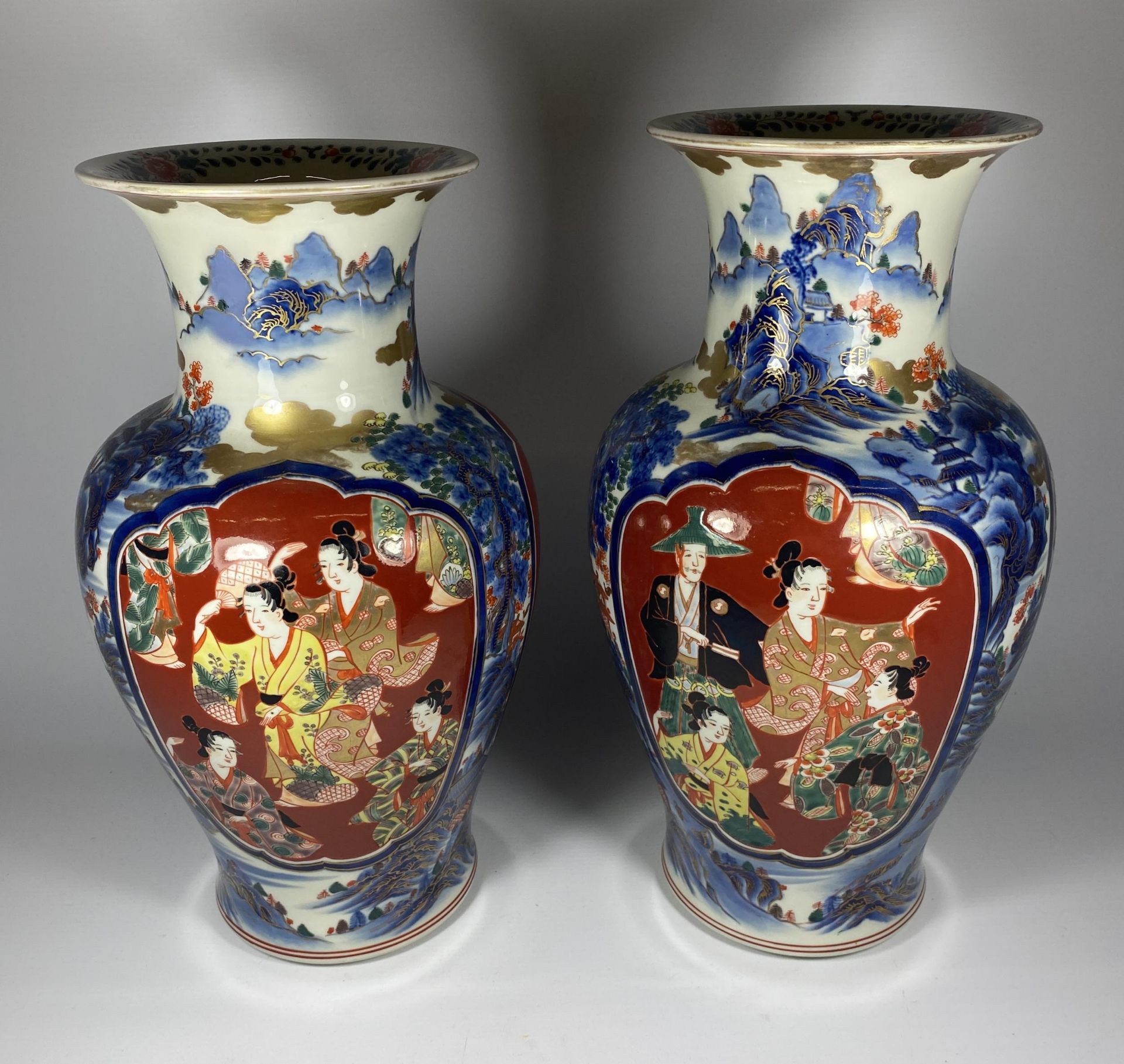 A LARGE PAIR OF JAPANESE MEIJI PERIOD (1868-1912) VASES WITH FIGURAL PANELS ON A MOUNTAIN