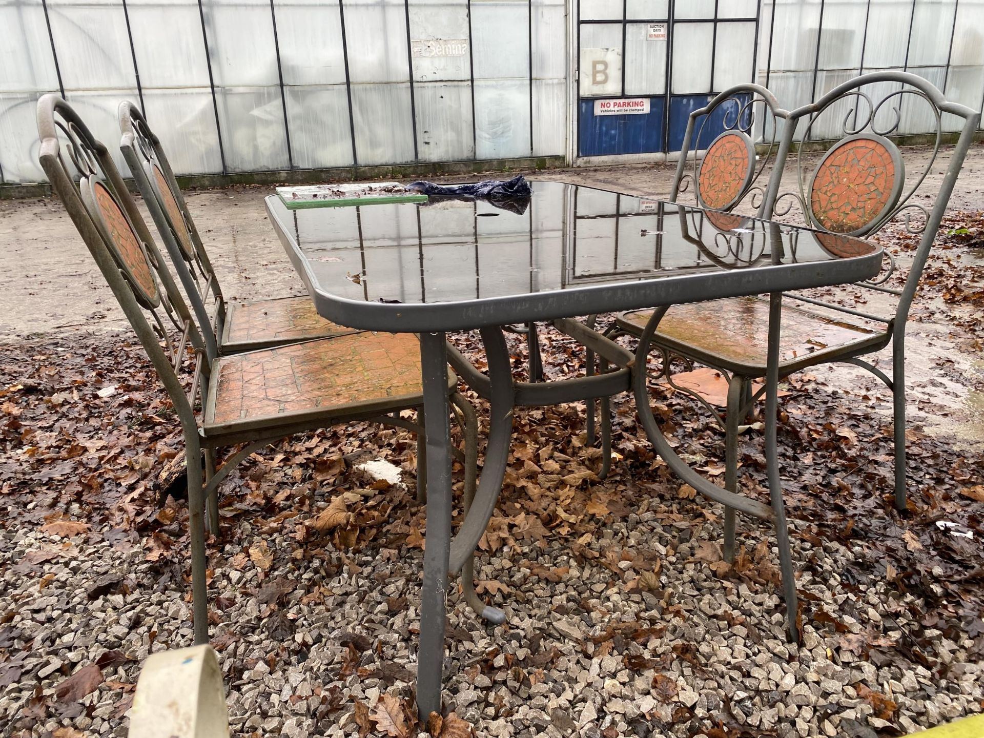 A GLASS TOPPED METAL GARDEN TABLE AND FOUR CHAIRS - Image 2 of 3