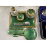 A VINTAGE GREEN ENAMEL BACKED DRESSING TABLE SET COMPRISING TRAY, BRUSHES, MIRROR AND POTS