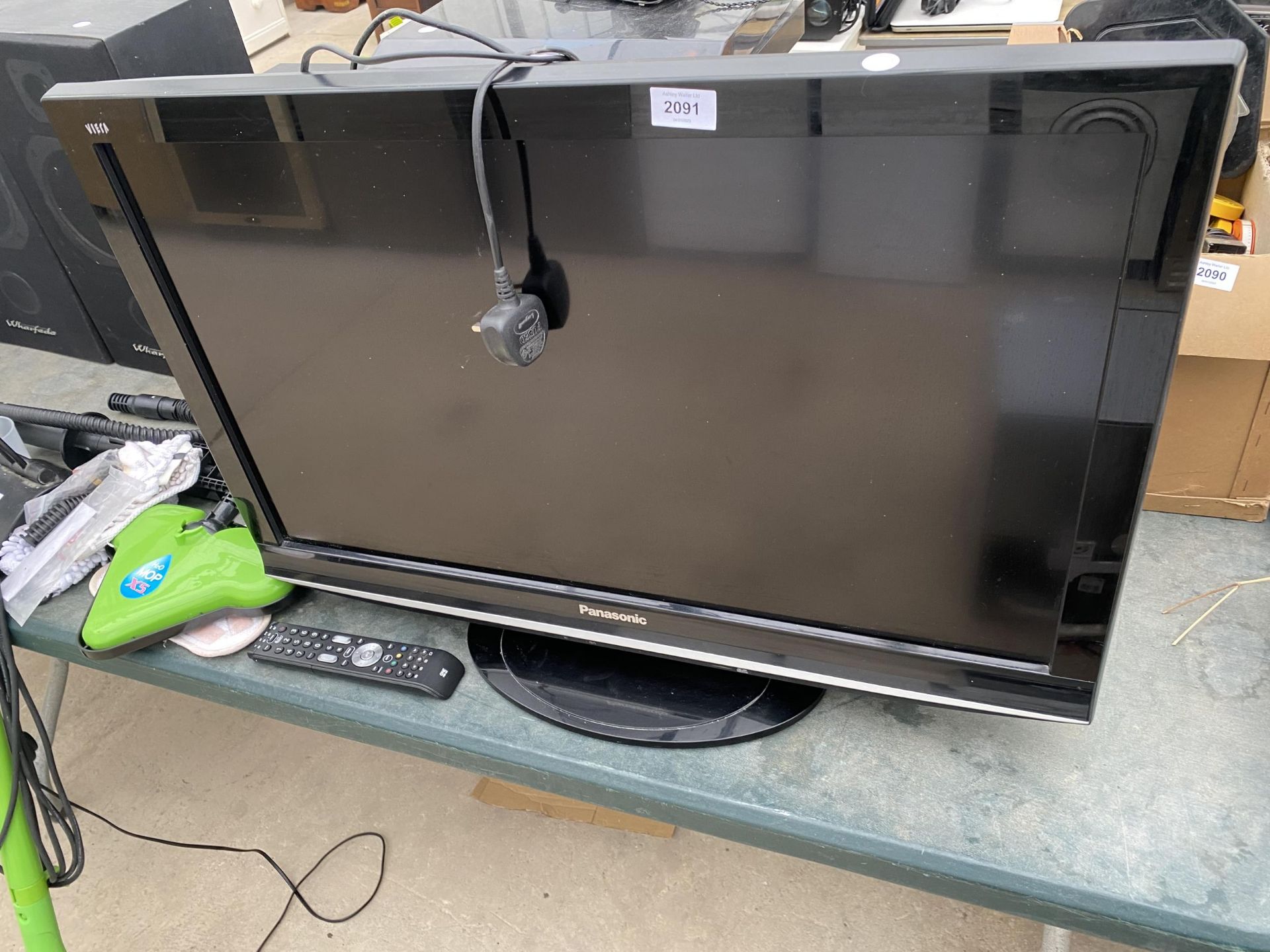 A PANASONIC 32" TELEVISION WITH ONE FOR ALL REMOTE CONTROL