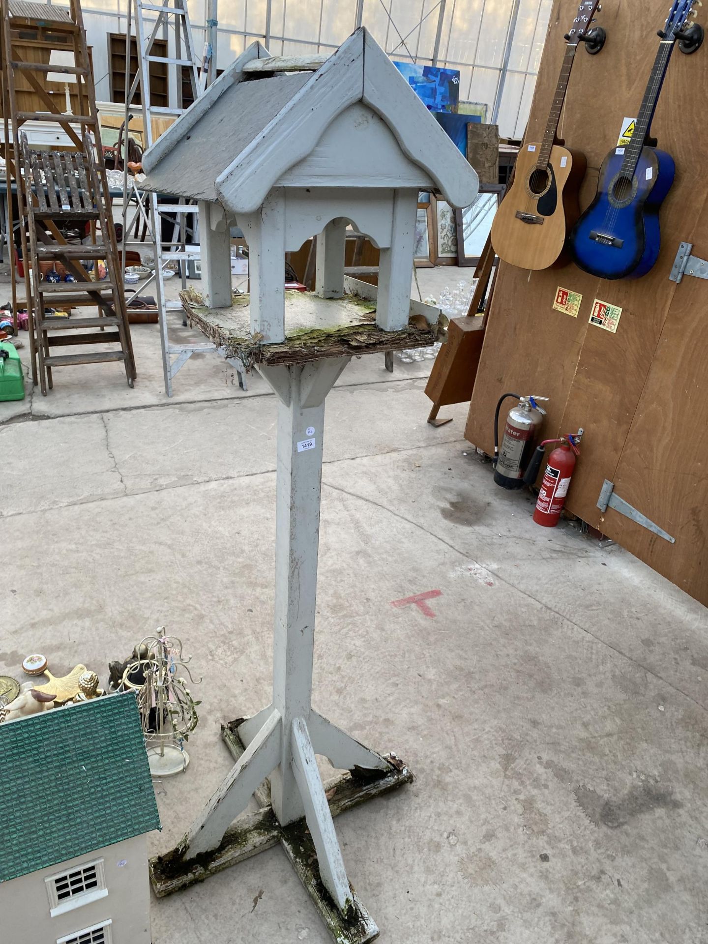 A WOODEN BIRD TABLE WITH SLATE ROOF