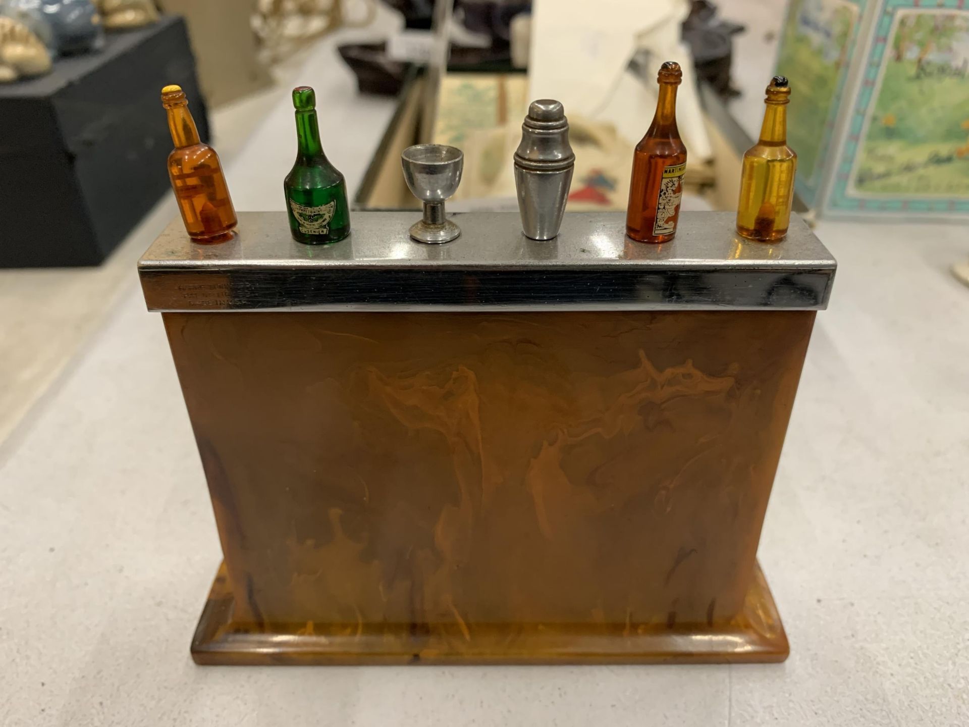A QUIRKY BAKELITE COCKTAI BAR WITH BOTTLES AND A COCKTAIL SHAKER COCKTAIL STICKS, HEIGHT 12CM, WIDTH