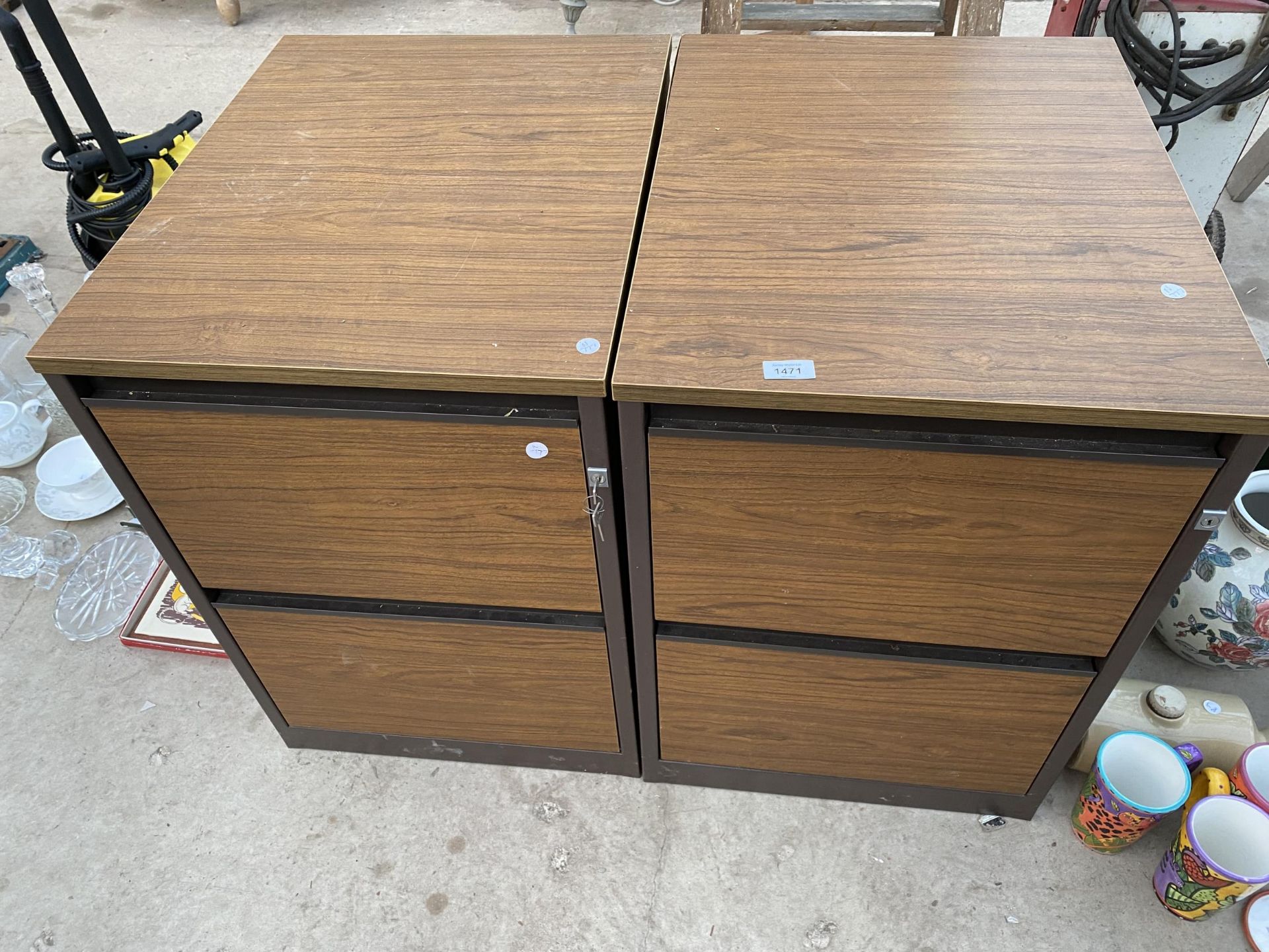 A PAIR OF WOODEN TWO DRAWER FILING CABINETS