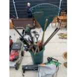 A LARGE ASSORTMENT OF TOOLS TO INCLUDE AN ELECTRIC LEAF BLOWER, RAKE AND PICK AXE ETC