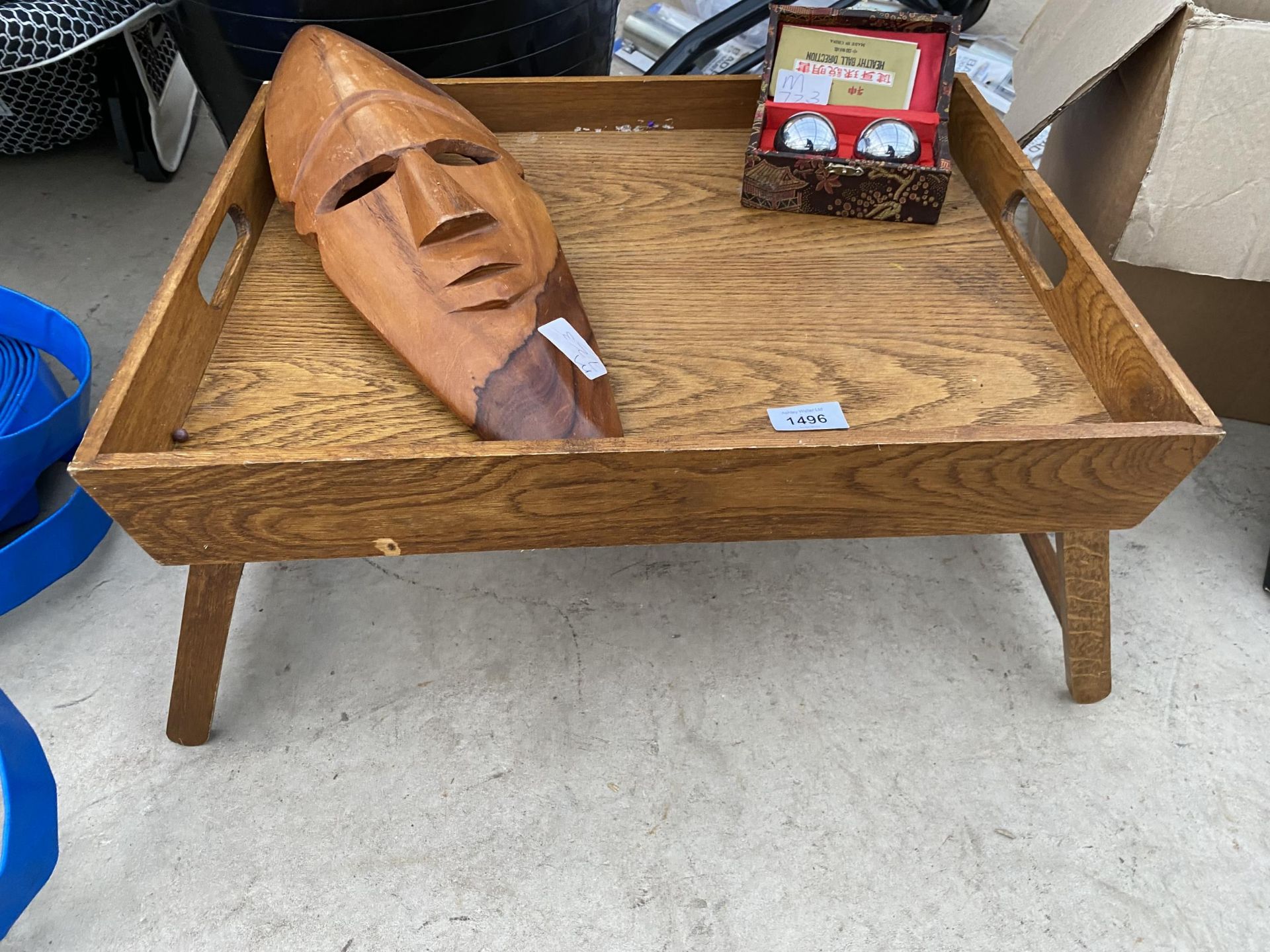 A WOODEN BREAKFAST TRAY, A TREEN WALL MASK AND A SET OF ORIENTAL HEALTH BALLS