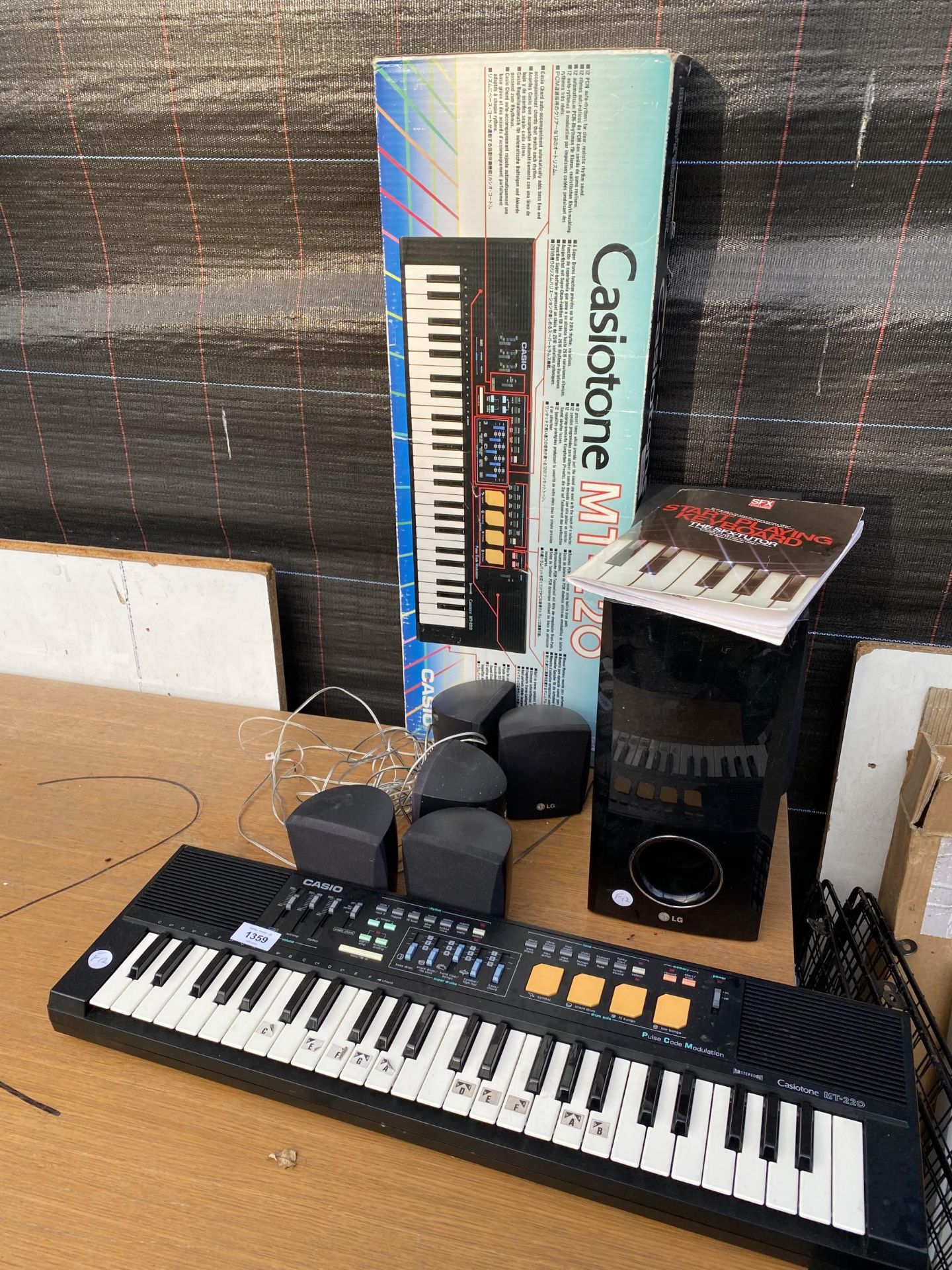 A CASIO CASIOTONE MT-220 KEYBOARD AND A LG SPEAKER SYSTEM