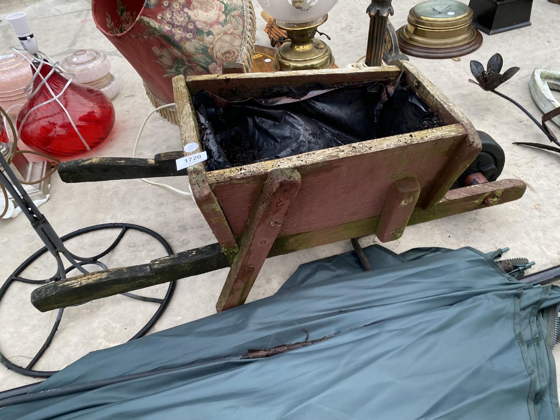 A WOODEN WHEEL BARROW PLANTER, A WROUGHT IRON PLANTER AND A FISHING BROLLY - Image 2 of 5