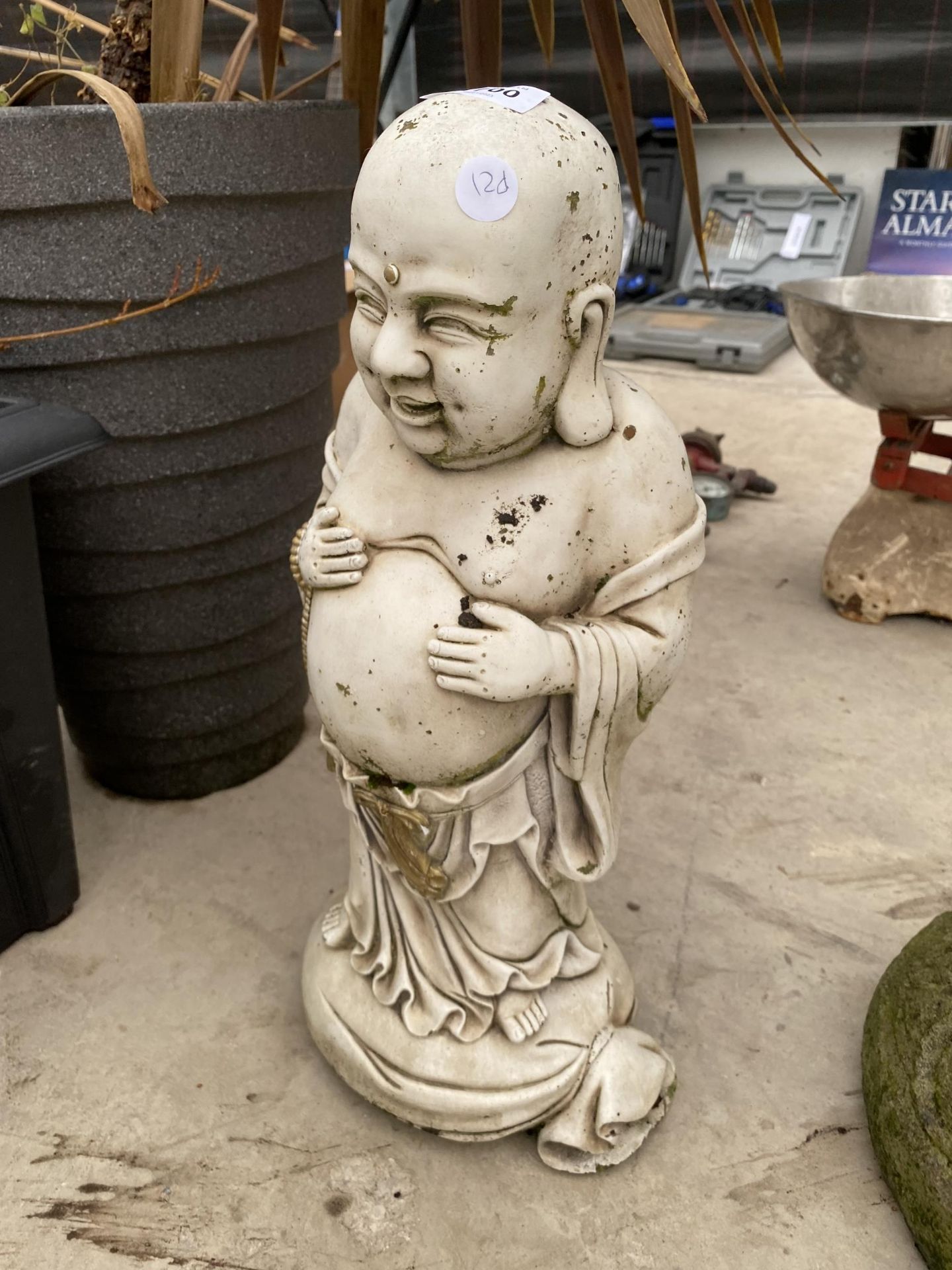 A RECONSTITUTED STONE BUDDAH FIGURE