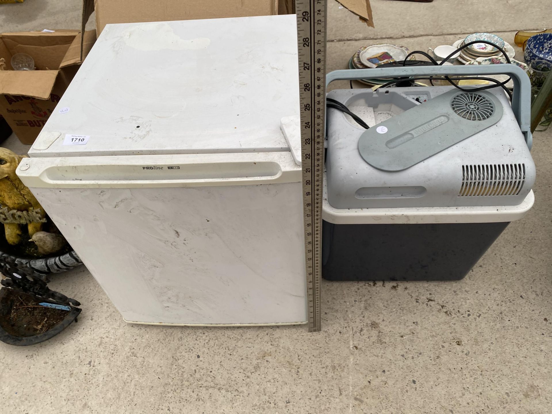 A WHITE PROLINE COUNTER TOP FRIDGE AND AN ELECTRIC COOL BOX
