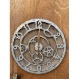 A METAL BOTTLE CAP STYLE WALL CLOCK WITH COG DETAIL