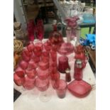 A LARGE QUANTITY OF CRANBERRY GLASS TO INCLUDE DRINKING GLASSES, VASES, JUGS, DECANTER, ETC.,