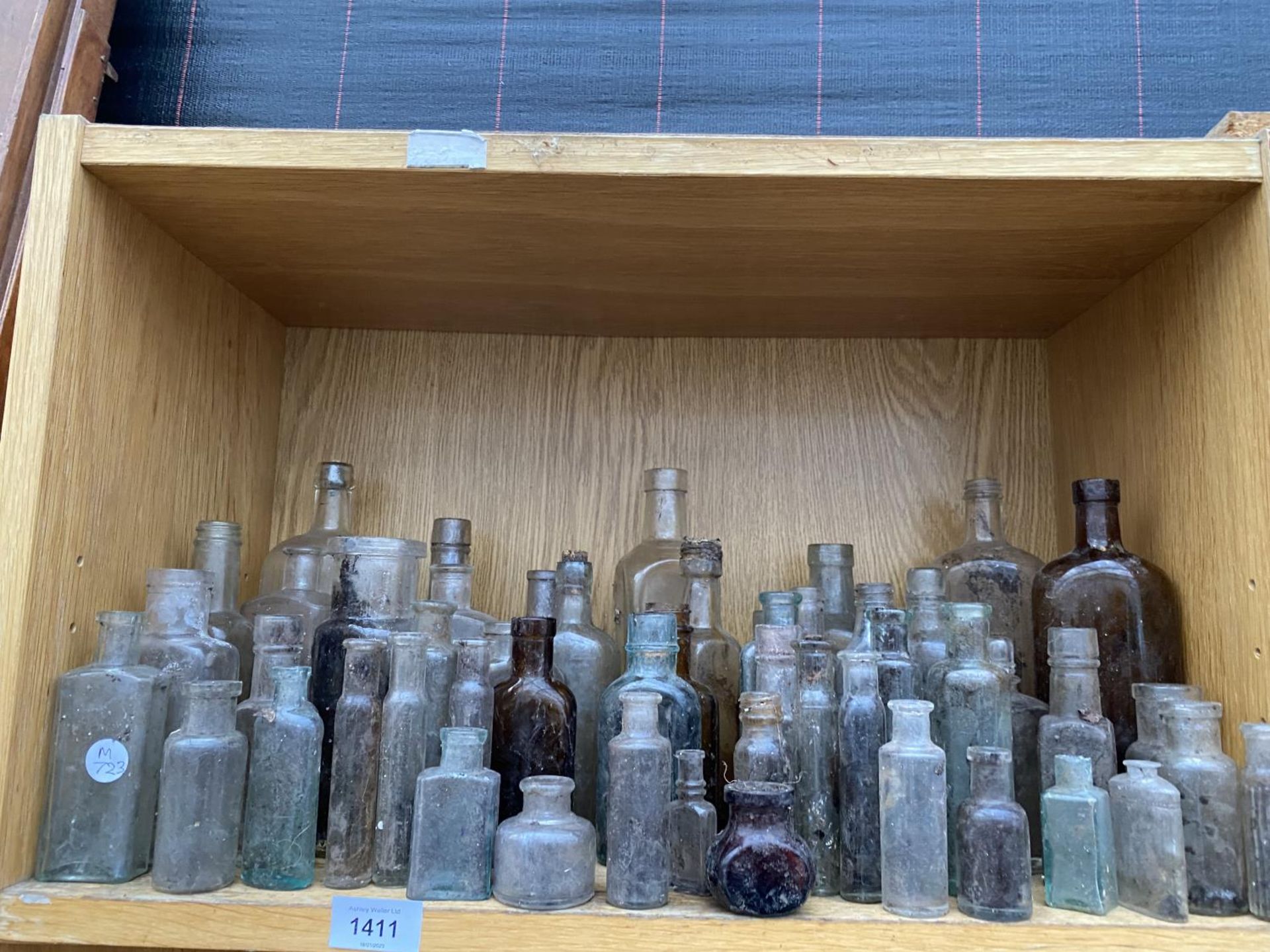 A LARGE QUANTITY OF MINITURE GLASS MEDICINE BOTTLES