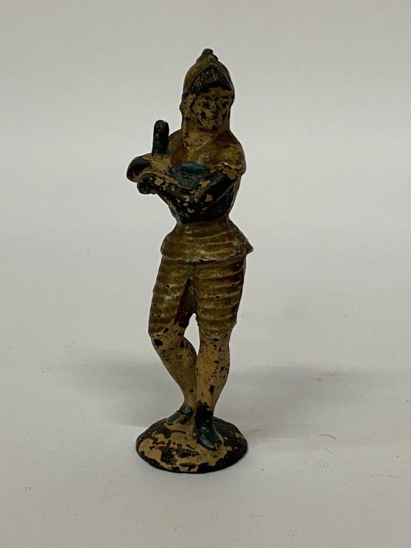 AN UNUSUAL, POSSIBLY BRONZE, MODEL OF A SWORDSMAN