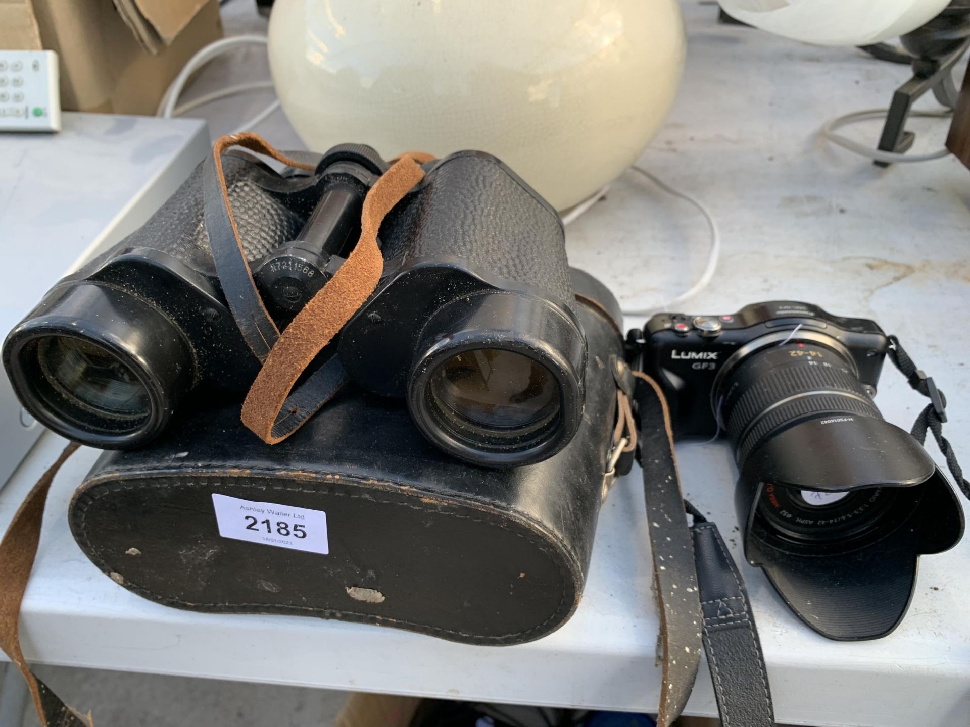 A PAIR OF BINOCULARS AND A LUMIX DIGITAL CAMERA