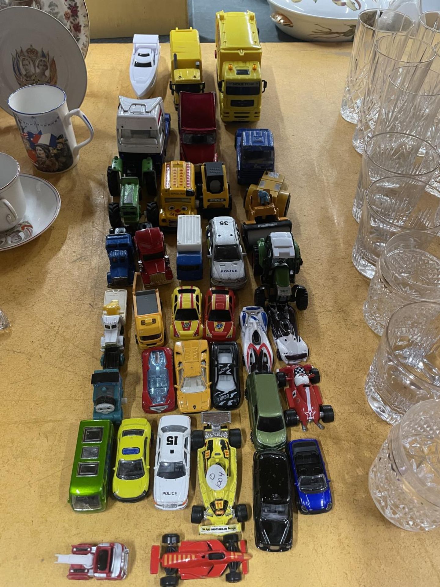 A LARGE QUANTITY OF TOY VEHICLES TO INCLUDE TRUCKS AND CARS, ETC