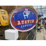 AN ILLUMINATED OVAL 'AUSTIN' SIGN