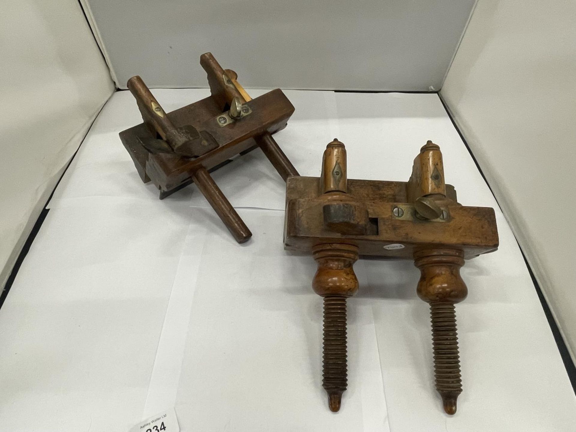 AN ANTIQUE FRUITWOOD PLOUGH PLANE TOGETHER WITH A THUMB SCREW PLOUGH