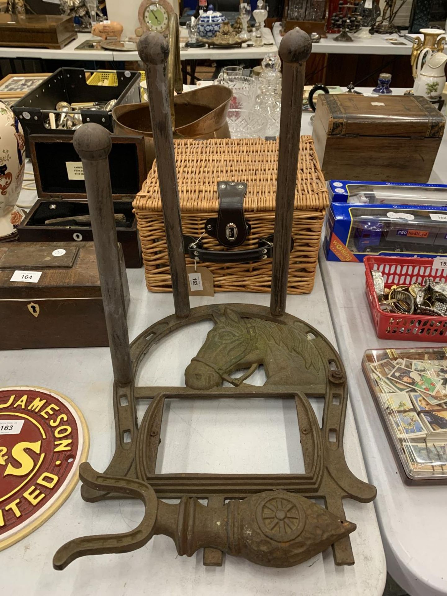 A VINTAGE CAST IRON BOOT SCRAPER AND WELLINGTON HOLDER WITH HORSESHEAD DECORATION