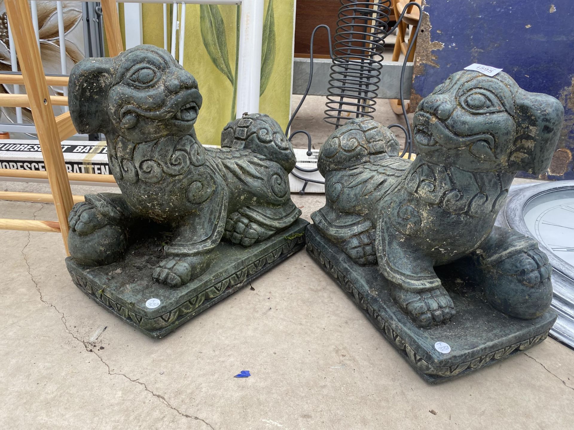 A PAIR OF RECONSTITUTED STONE ORIENTAL STYLE LIONS