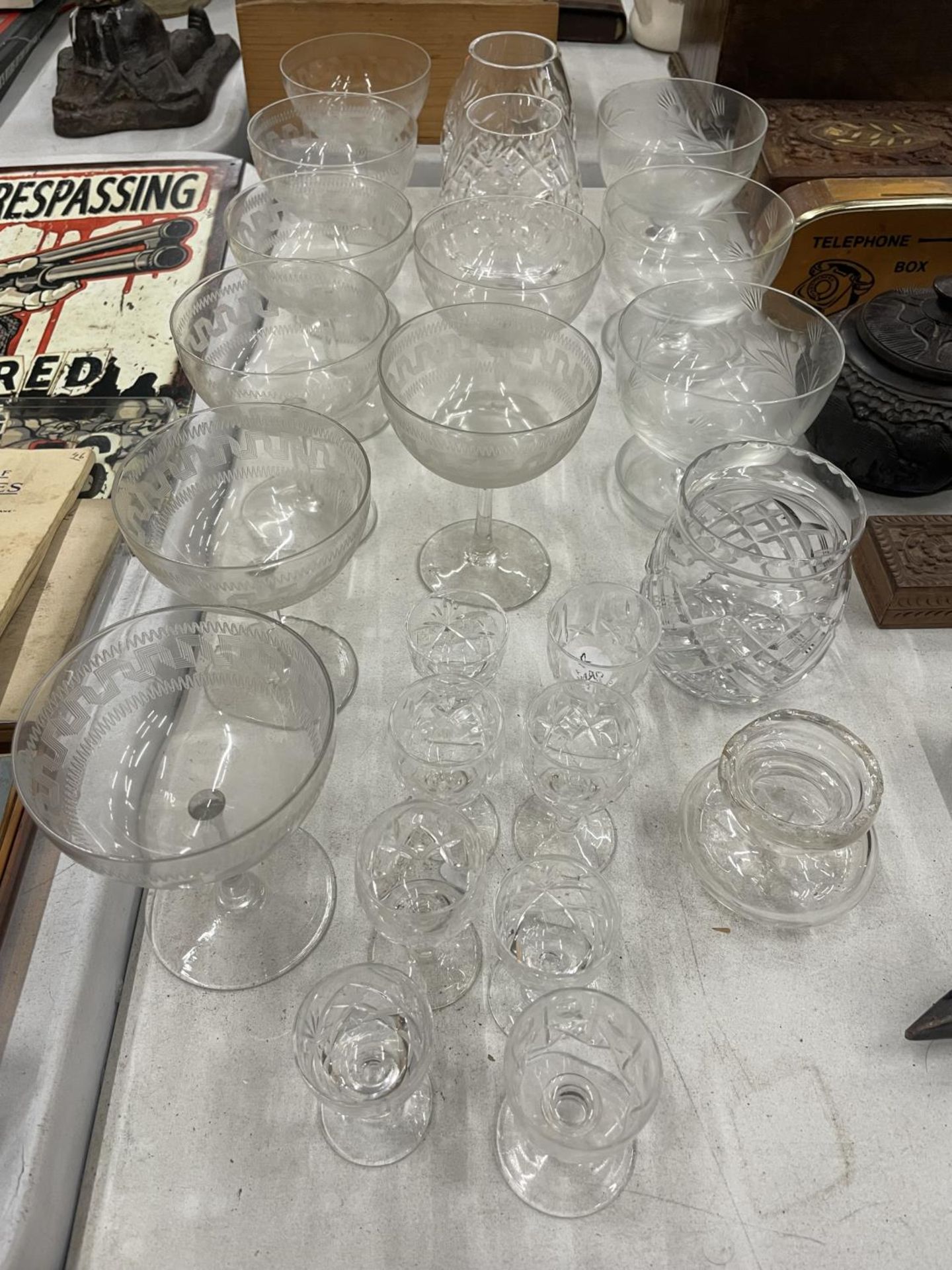 A QUANTITY OF GLASSWARE TO INCLUDE BRANDY GLASSES, CHAMPAGNE GLASSES, SHERRY GLASSES ETC.,