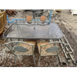 A GLASS TOPPED METAL GARDEN TABLE AND FOUR CHAIRS