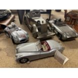 FOUR MODELS OF CARS TO INCLUDE A JIM BAMBER LIMITED EDITION 325/2000 TRIBUTE PIECE TO STIRLING MOSS,