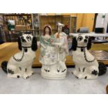 THREE STAFFORDSHIRE POTTERY ITEMS - PAIR OF BLACK AND WHITE SPANIELS AND A FLATBACK FIGURE GROUP