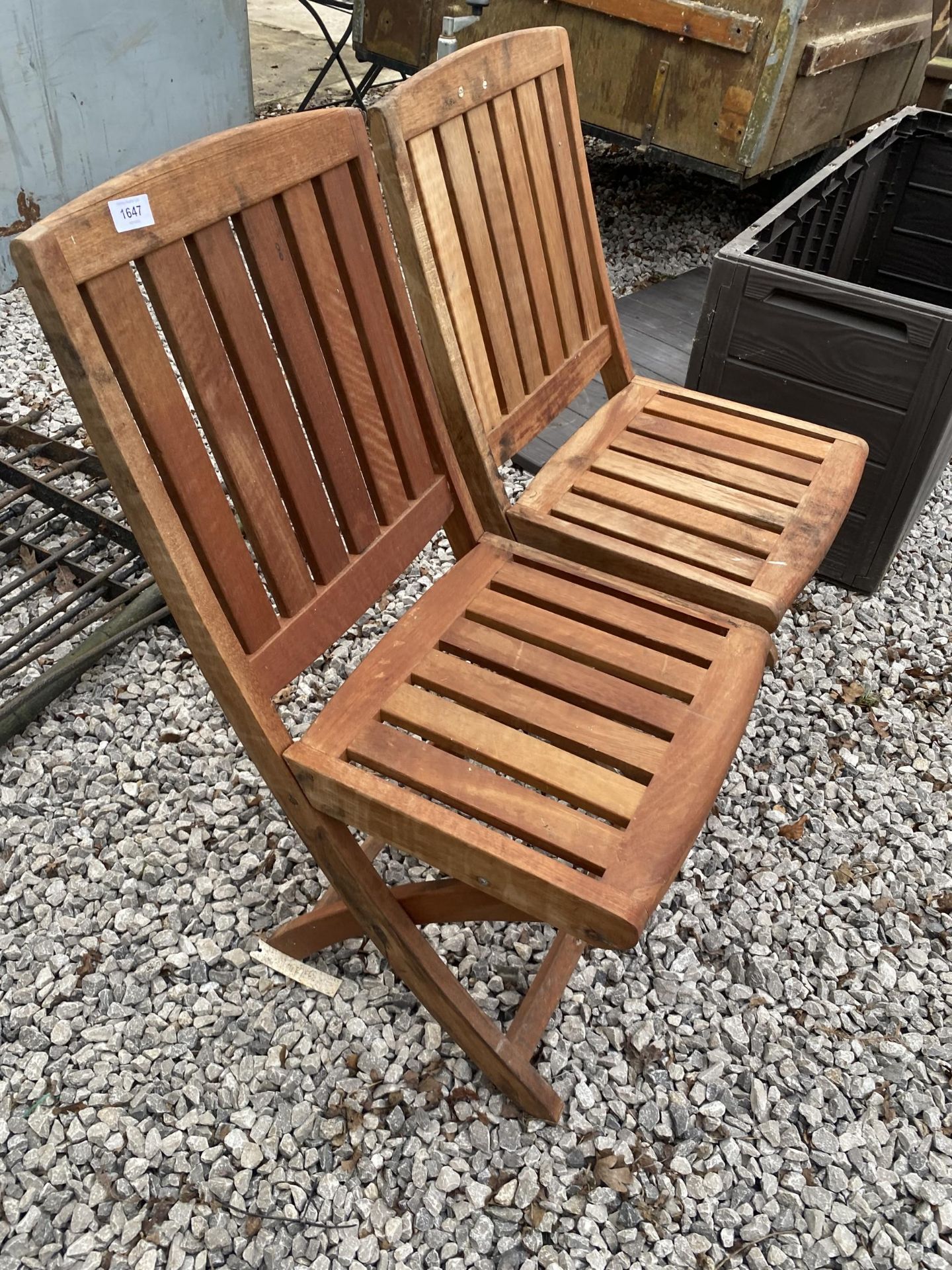 A PAIR OF TEAK FOLDING GARDEN CHAIRS