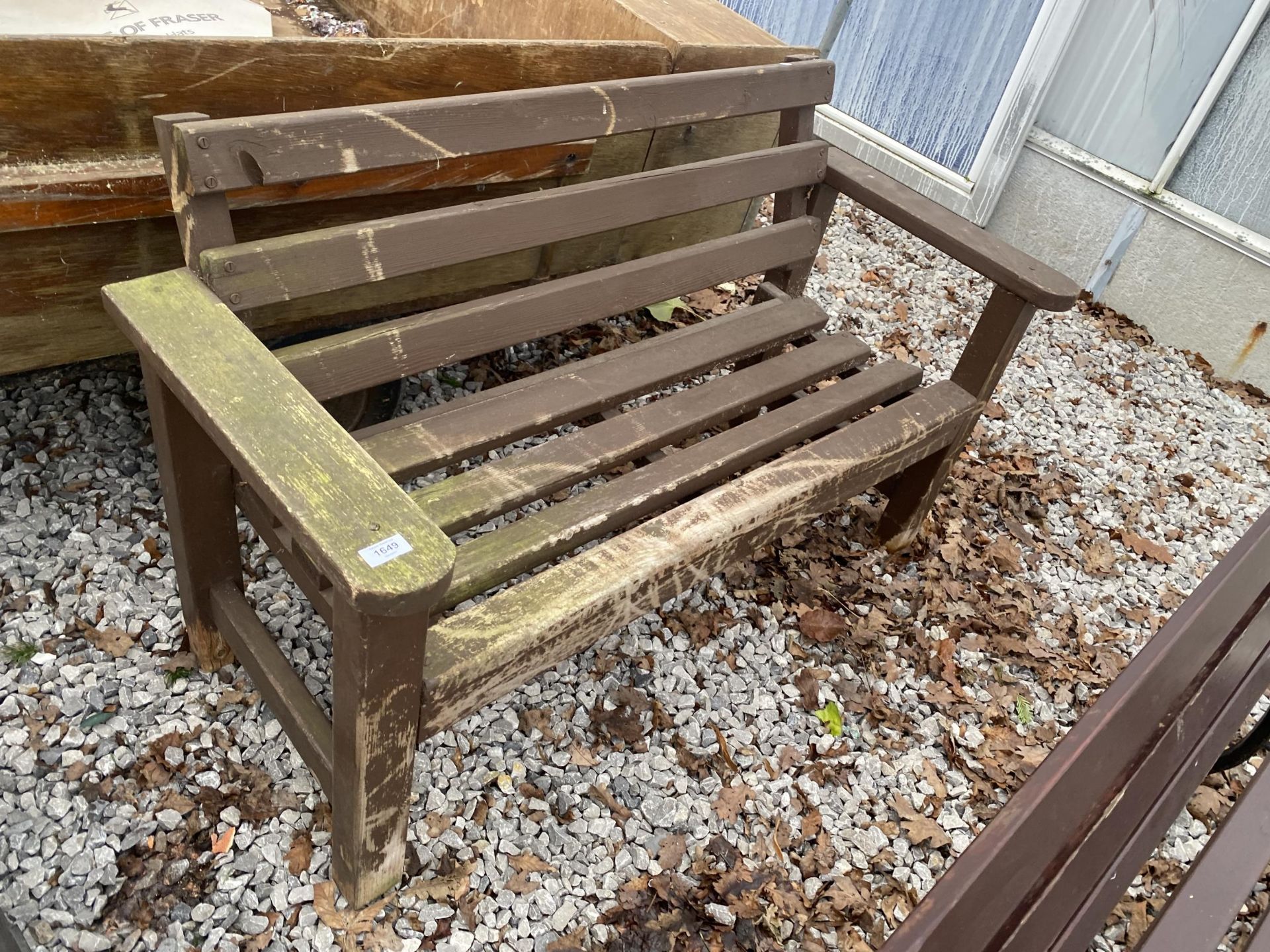 A TWO SEATER WOODEN GARDEN BENCH