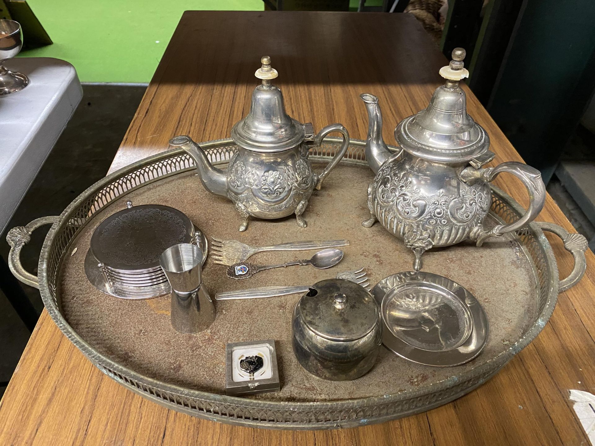 A SILVER PLATED LARGE GALLERIED TRAY, COFFEE POTS WITH EMBOSSED DECORATION, PRESERVE POT,