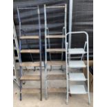 TWO FIVE RUNG TUBULAR METAL STEP LADDERS AND A FURTHER METAL THREE RUNG STEP LADDER