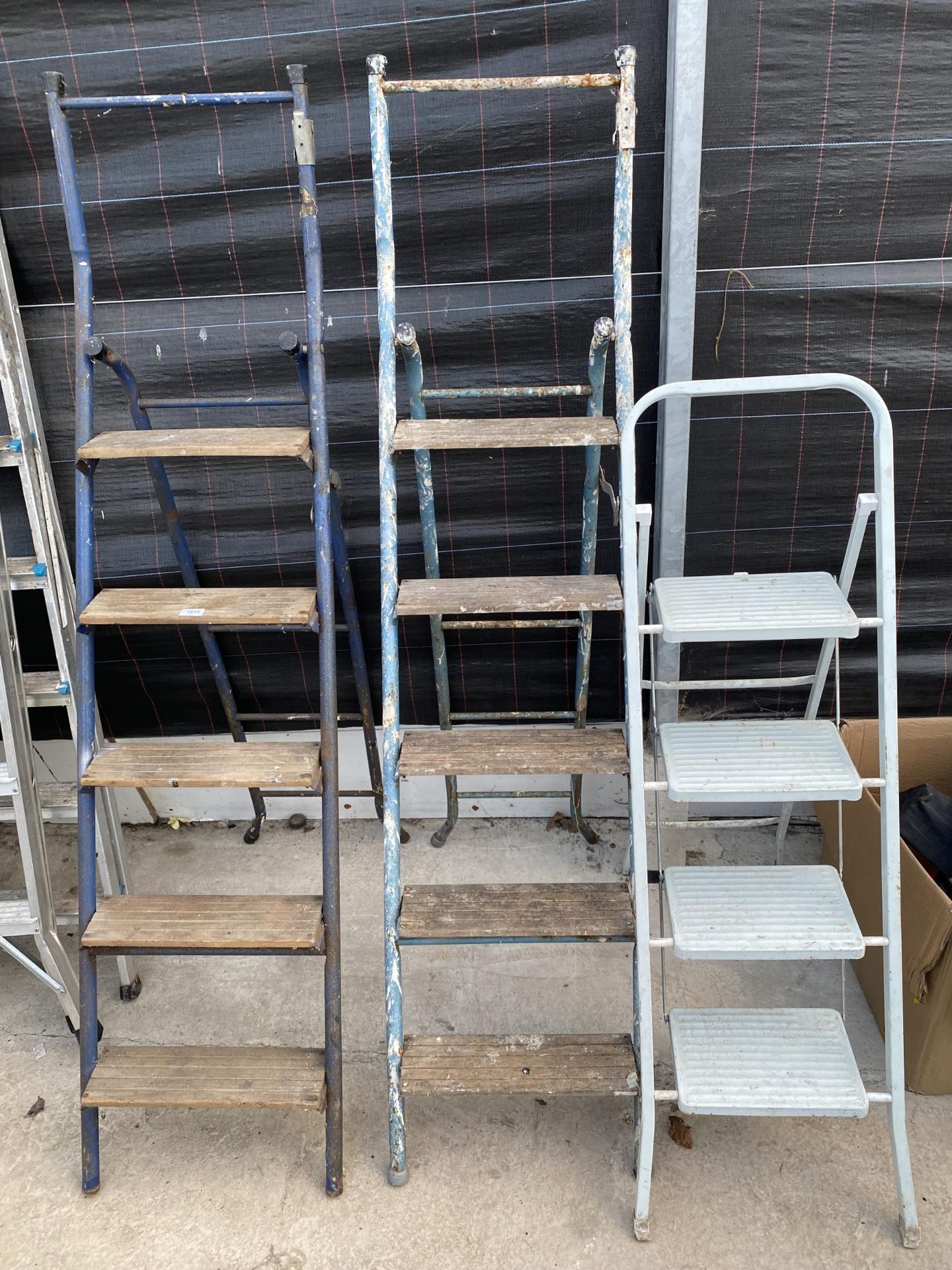 TWO FIVE RUNG TUBULAR METAL STEP LADDERS AND A FURTHER METAL THREE RUNG STEP LADDER