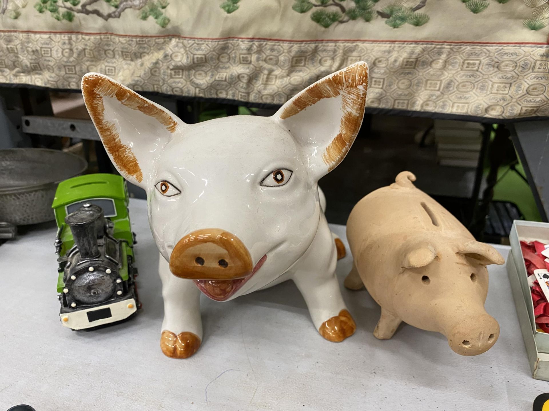 THREE CERAMIC MONEY BOXES ONE BEING A LARGE PIG