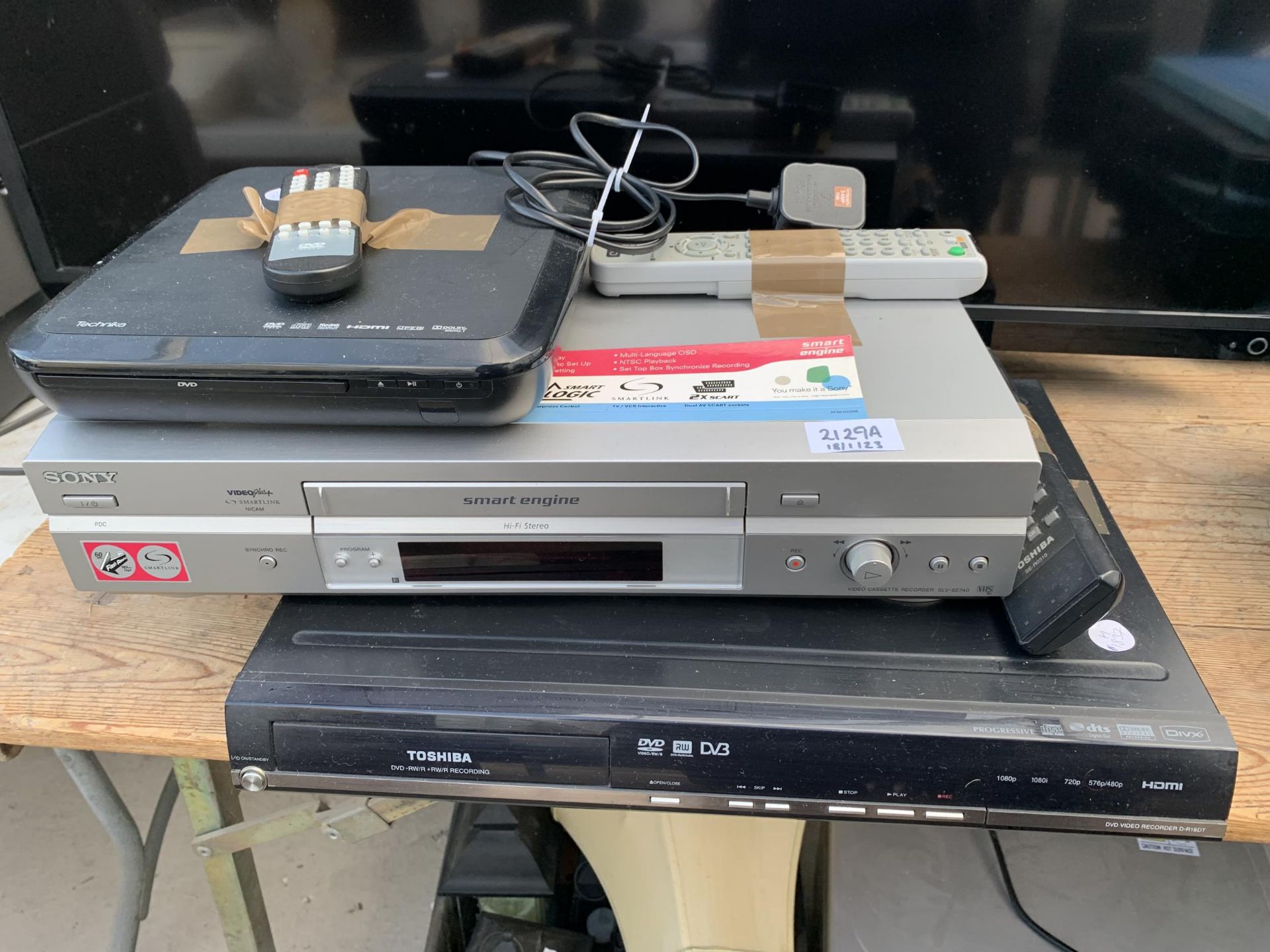 A TOSHIBA DVD PLAYER, A SONY VHS PLAYER AND A TECHNIKA DVD PLAYER ETC