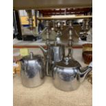 A STAINLESS STEEL COFFEE POT, TEAPOT AND HOT WATER JUG PLUS TWO SILVER PALTED CANDLEABRAS EACH