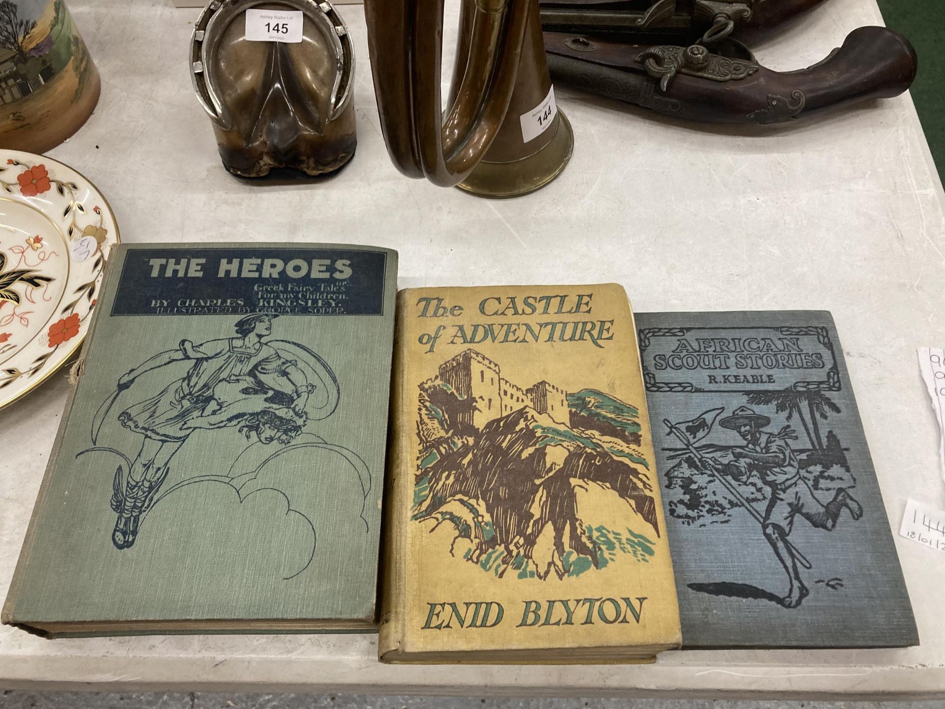 THREE VINTAGE HARDBACK BOOKS TO INCLUDE 'THE HEROES' CHARLES KINGSLEY, 'CASTLE OF ADVENTURE' ENID