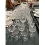 A QUANTITY OF CUT GLASS TO INCLUDE WINE GLASSES, CHAMPAGNE FLUTES, ETC
