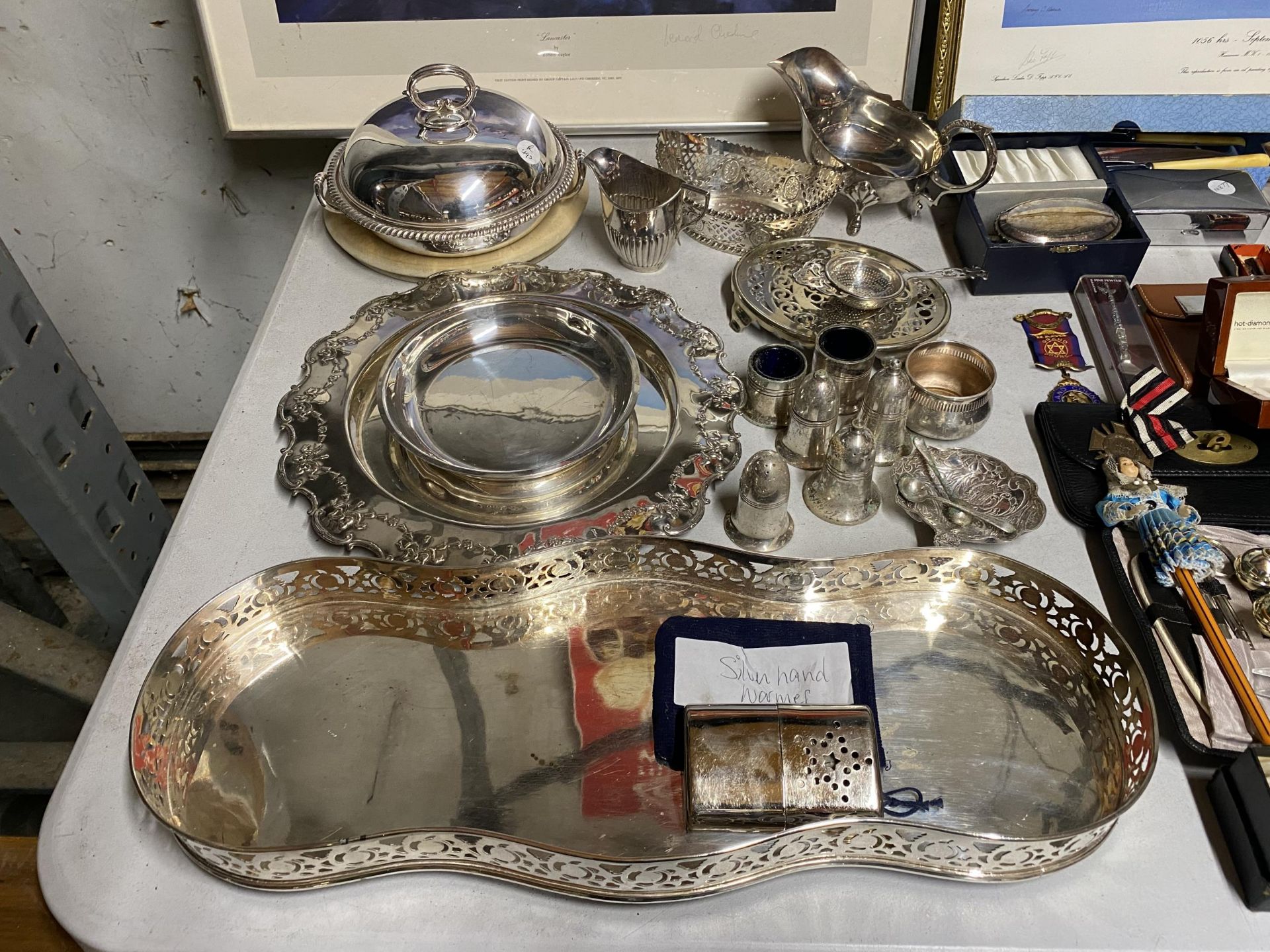 A LARGE QUANTITY OF ITEMS TO INCLUDE A SMALL HALLMARKED SILVER CREAM JUG, SILVER HAND WARMER, TRAYS,