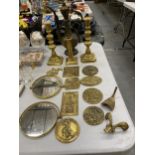 A QUANTITY OF VINTAGE BRASS MICHAELMAS FAIR PLAQUES, CANDLESTICKS AND A MIDDLE EASTERN STYLE